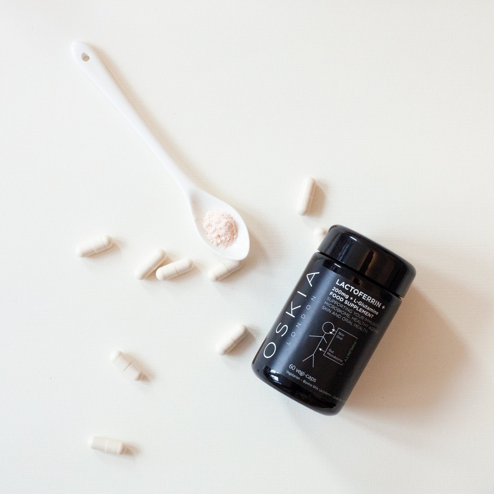 Lactoferrin supplement powder on a spoon
