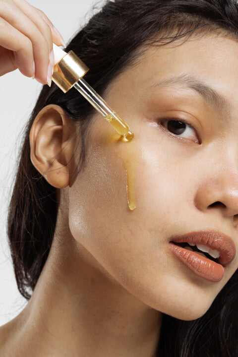 Lifestyle image of facial oil on a models face