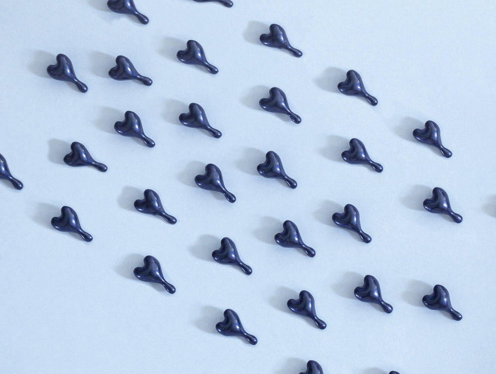 Image of OSKIA's Super R Capsules on blue paper