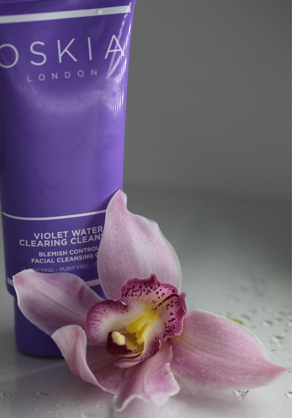 Violet Water Clearing Cleanser with a flower
