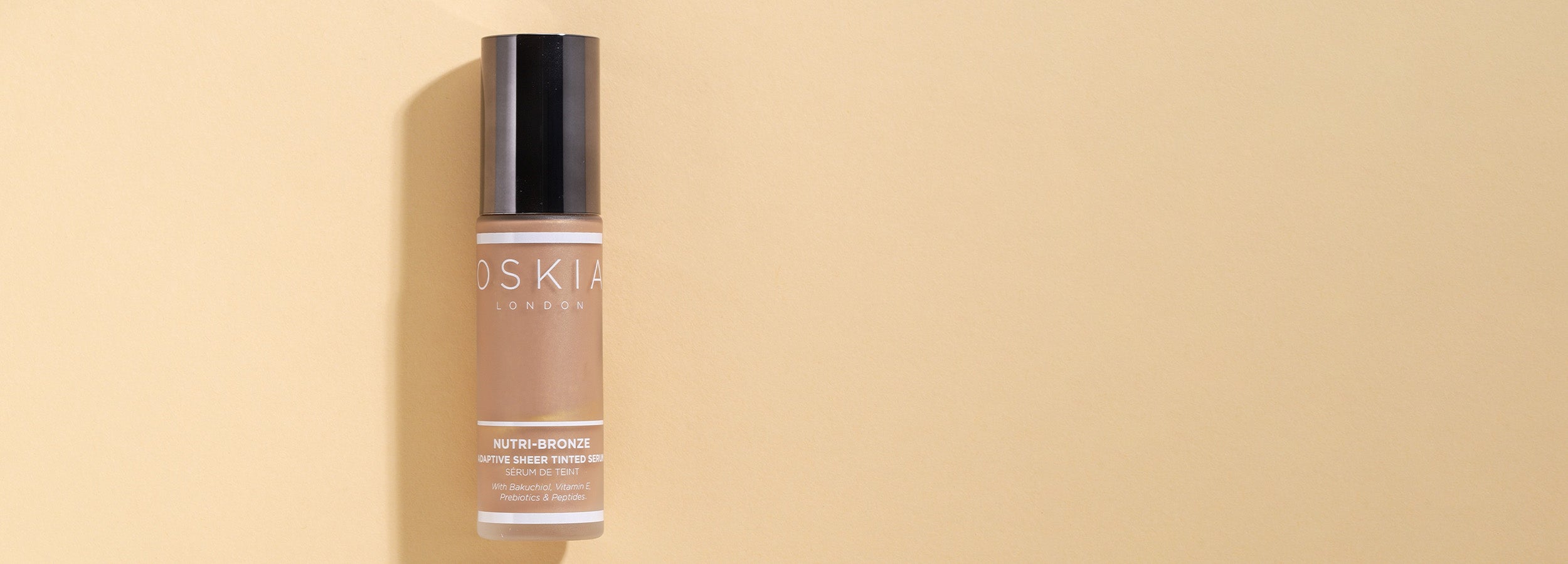 OSKIA's Nutri-Bronze Sheer Adaptive Tinted Serum on a yellow background